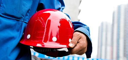 red hardhat in hand